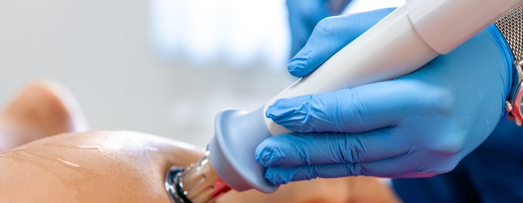Shock wave therapy, the magnetic field, rehabilitation, physiotherapist doctor performs surgery on a patient's shin, achilles tendon